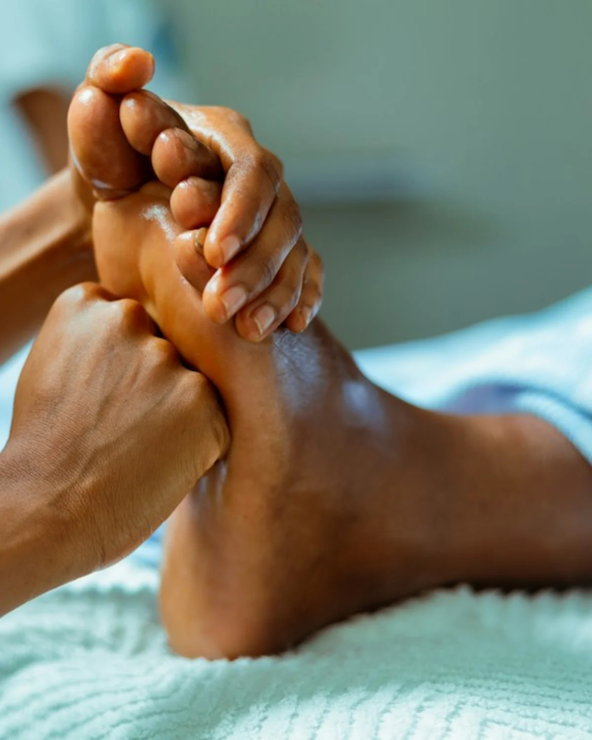 Demostración profesional de reflexología podal con presión manual sobre el pie